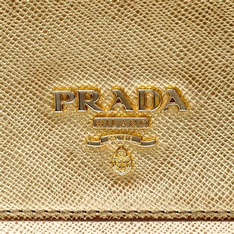 prada saffiano metallic gold flap wallet ราคา